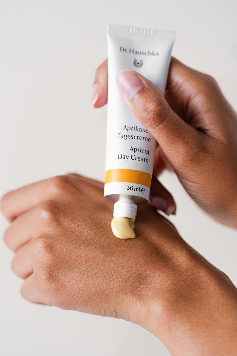 Cream applied to neck and décolletage for even coverage