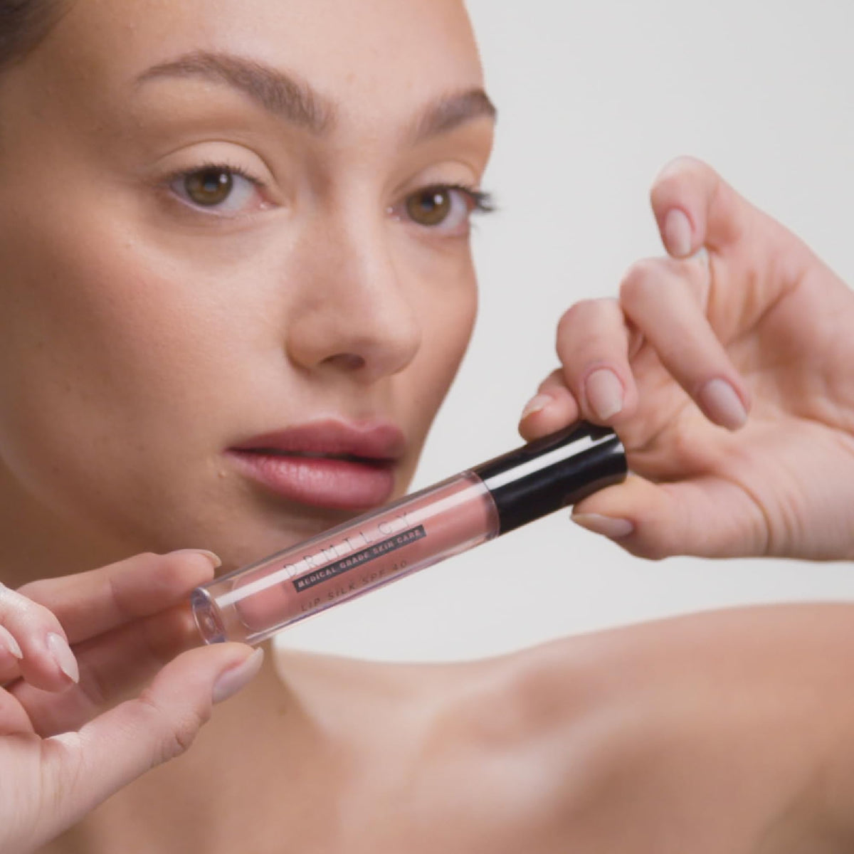 DRMTLGY Lip Silk SPF 40 No White Cast preserves a natural look under sun.