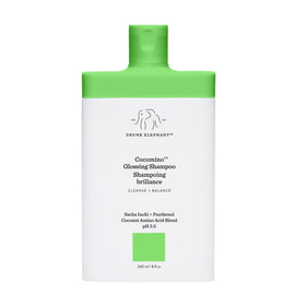 Drunk Elephant Cocomino Glossing Shampoo bottle demonstrates sulfate-free cleansing for color-safe hair.