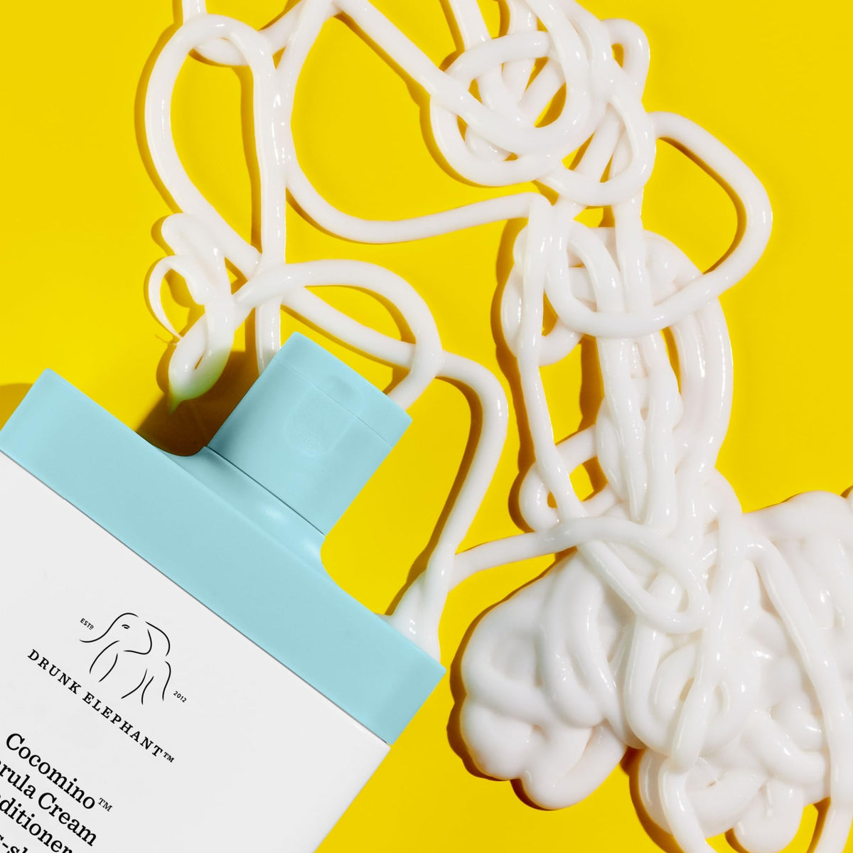 Drunk Elephant Cocomino Marula Cream Conditioner pouring shows detangling.
