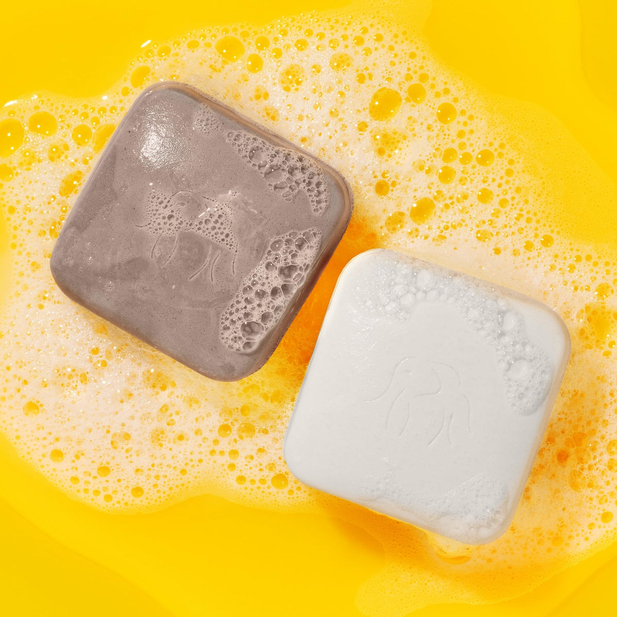 Drunk Elephant Juju Bar lather close-up shows creamy texture for gentle cleanse.