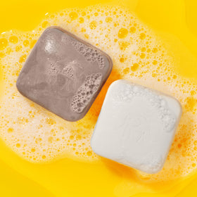 Drunk Elephant Juju Bar lather close-up shows creamy texture for gentle cleanse.