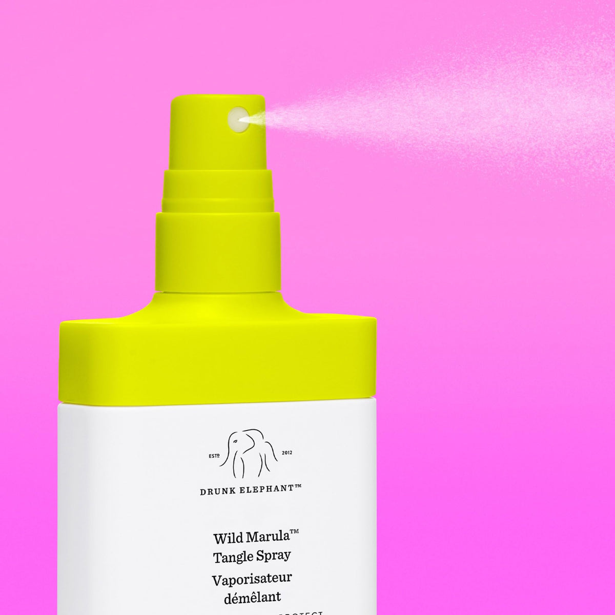Drunk Elephant Wild Marula Tangle Spray being applied to damp hair for detangling.