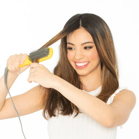 Drybar Baby Brush Crush Mini with universal voltage for global styling needs.