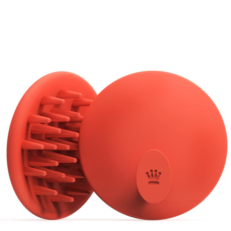 DS Laboratories scalp brush in hand for a refreshing scalp massage and residue lift.