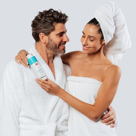 Hands applying DS Labs Dandrene shampoo for a refreshing cleanse.
