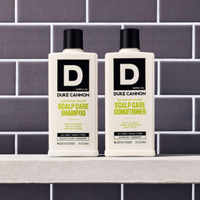 Duke Cannon scalp care duo in a bathroom setup ready to use.