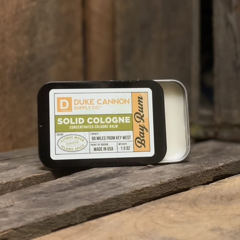 Duke Cannon Bay Rum solid cologne in gym bag setup for on-the-go use.