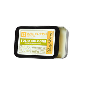 Duke Cannon Bay Rum solid cologne tin close-up, travel-friendly packaging.