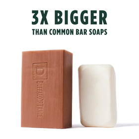 Duke Cannon Big American Bourbon soap bar in shower setup for rugged grooming