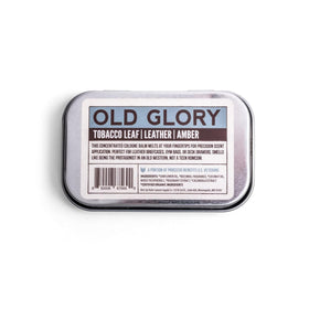 Duke Cannon Old Glory solid cologne tin open reveals concentrated balm for precise application.