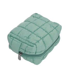 Green checkered travel case keeps toiletries neatly in one place.