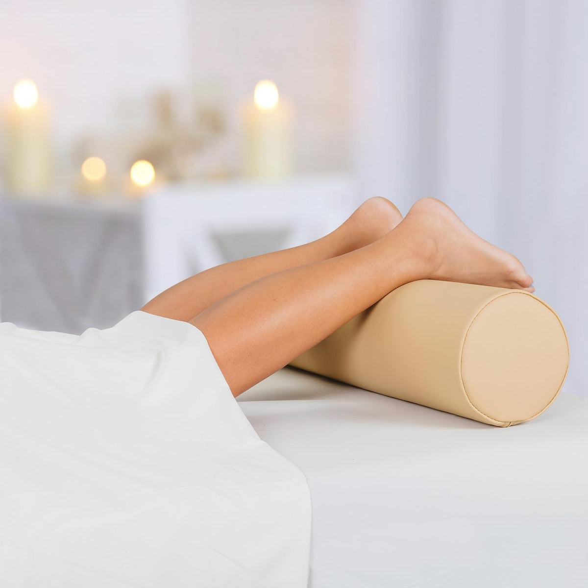 EarthLite bolster under ankle support for face-down sessions enhances alignment.