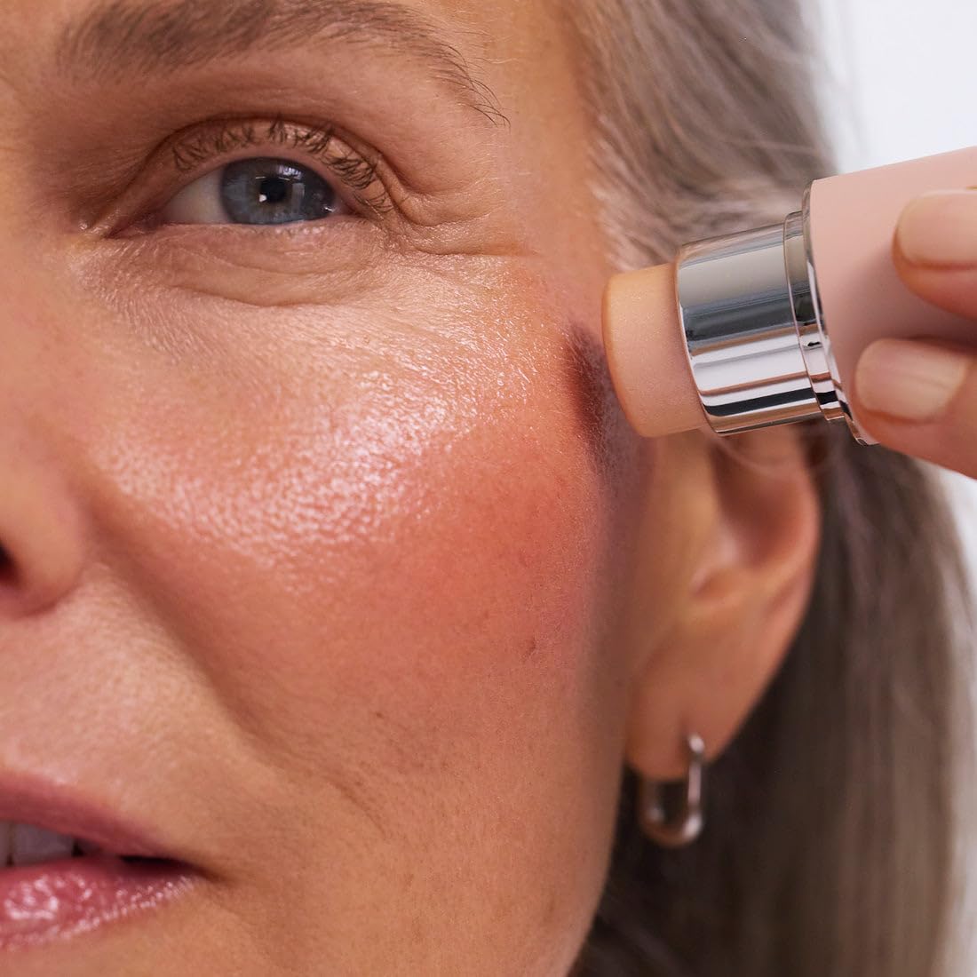 EarthsCure Glow Glaze highlighter stick on cheeks for daytime radiance.
