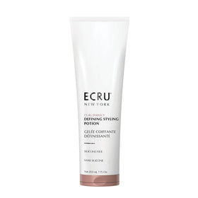 ECRU New York Curl Perfect Defining Potion bottle pour for smooth frizz control.