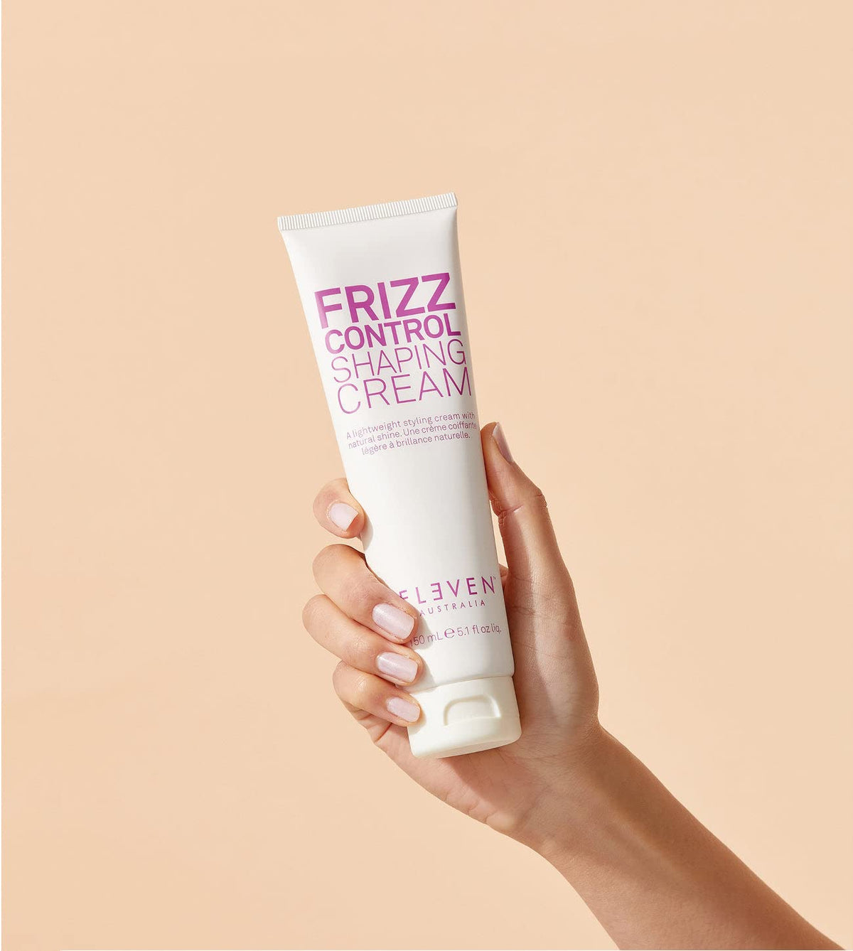 Twisting damp hair sections to reveal curl definition with ELEVEN AUSTRALIA Frizz Control Cream.