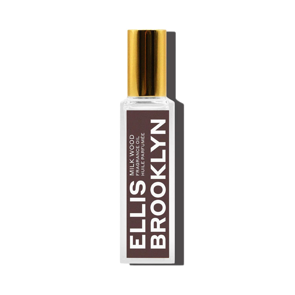 Ellis Brooklyn Milk Wood perfume oil bottle close-up highlighting creamy coconut notes for everyday wear.