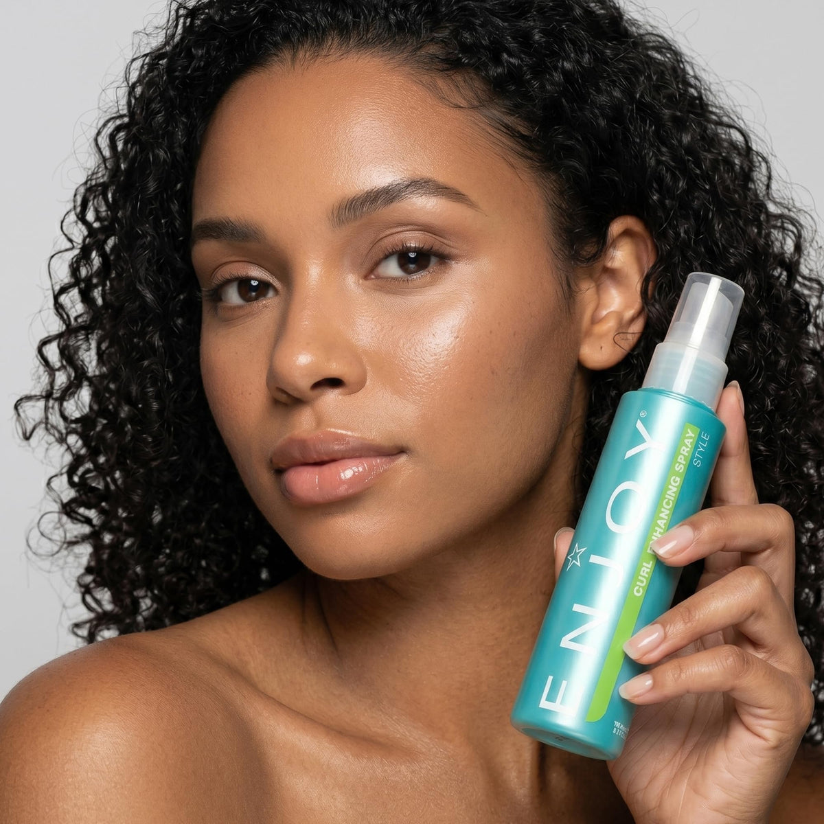 Enjoy Curl Enhancing Spray application scene highlights quick styling confidence.