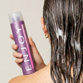 Close-up of Enjoy Luxury Conditioner cream texture for rich moisture