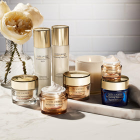 Estée Lauder product staged by a bed showing nighttime routine convenience while traveling