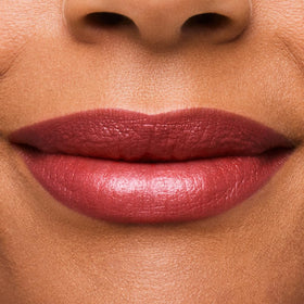Swatch of Rebellious Rose showing shimmering, dimensional glow on lips.