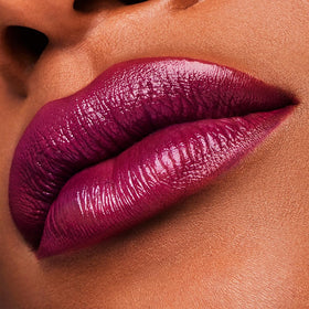 Estée Lauder Insolent Plum on lips offers satin finish