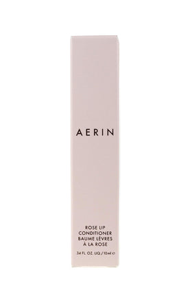 Estee Lauder Rose Lip Conditioner on lips, revealing petal-pink sheen.