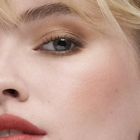 Estée Lauder Peach Passion swatch showing buildable color and glow.