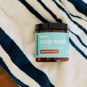 Bottle pour of Everyone Scrub demonstrating easy scalp application