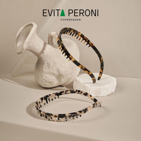 EVITA PERONI headband provides secure bang control during wear.
