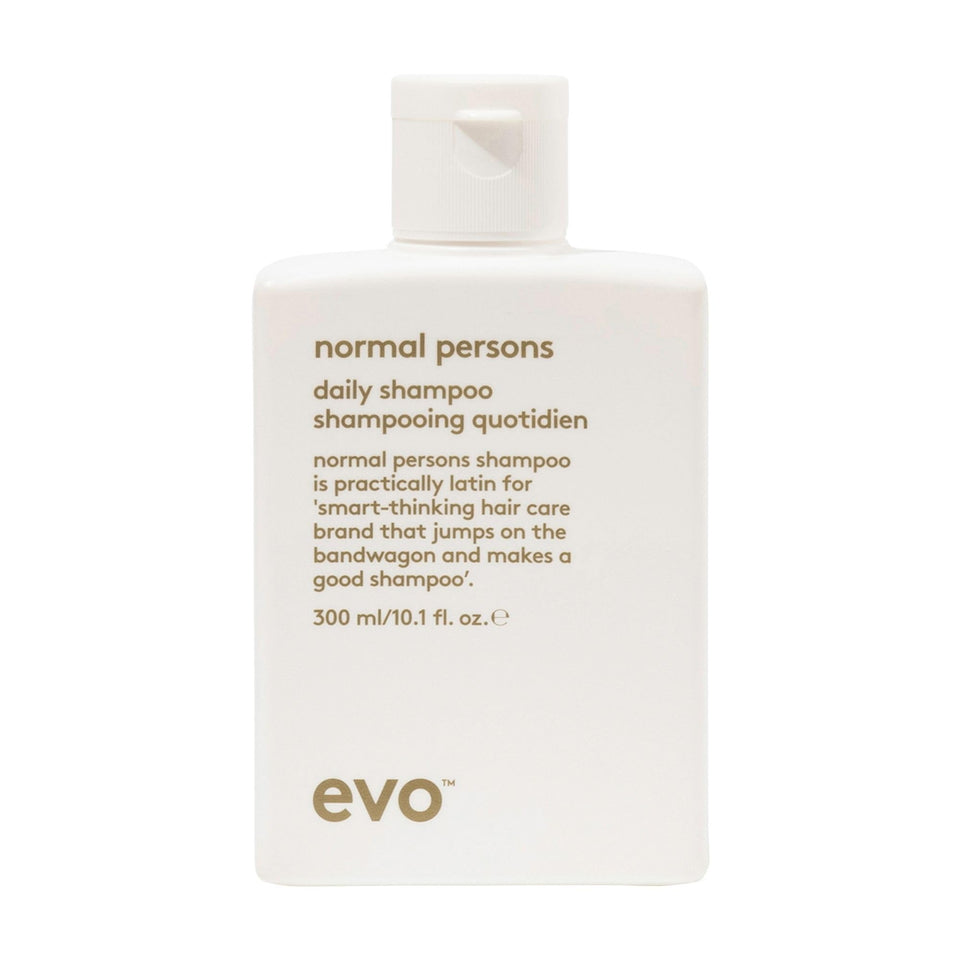 EVO Normal Persons Daily Shampoo bottle pour demonstrates deep cleanse and buildup removal.