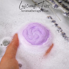 EvolutionUSA Lavender Dreams bath bomb fizzing in tub with vibrant color release.