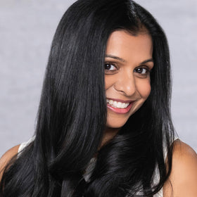 Model showcasing visibly shiny, smooth hair after using EVOLVh UltraShine Moisture Conditioner.