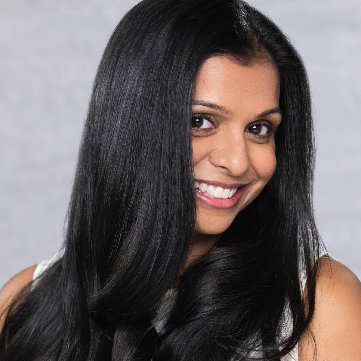 EVOLVh UltraShine shampoo label close-up emphasizes a clean, vegan formula.