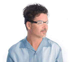 EYEECO Sleep Mask worn over eyes demonstrating an adjustable strap for a personalized fit.