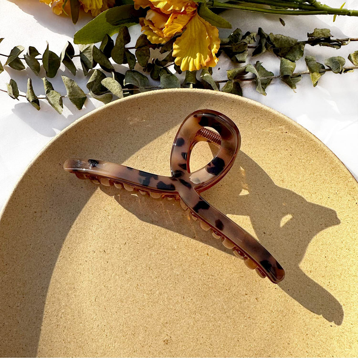 In-use shot demonstrates securing a ponytail for everyday styling.