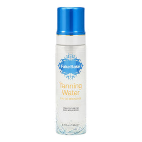 Fake Bake Foam Tanning Water bottle in focus for easy at home sunless tanning.