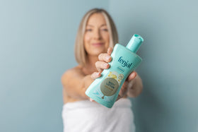 Hands applying Fenjal Classic lotion for smooth, hydrated skin.