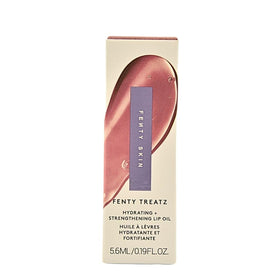 Fenty Beauty Treatz lip oil on lips delivers a glassy, non-sticky finish.