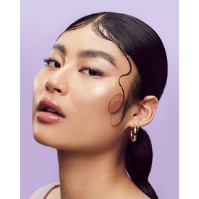 Applying Fenty edge gel smooths edges for a polished look.