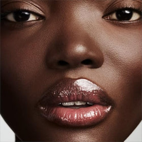FENTY RIRI Lip Gloss on lip shows natural shimmer and glow