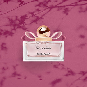 Ferragamo Signorina EDP glass bottle with pink liquid close-up.