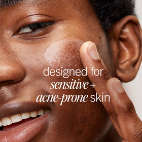 Product label closeup of First Aid Beauty Lactic Lotion highlighting low-pH Niacinamide