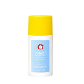 First Aid Beauty weightless sunscreen bottle close-up; sheer tint blends for a natural satin finish.