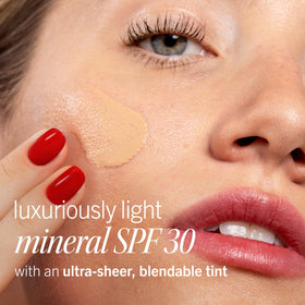 First Aid Beauty weightless sunscreen pump bottle showing silky texture for easy blending.