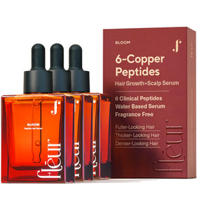 Fléur Bloom serum bottle close-up showing copper peptide formula for hair support