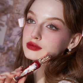Flower Knows bottle close-up showcases Rococo packaging and vegan formula.