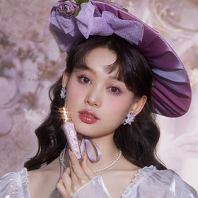 Flower Knows gloss on lips shows optical plumping with shimmering finish.