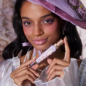 Flower Knows lip gloss on lips with soft, luminous glow.