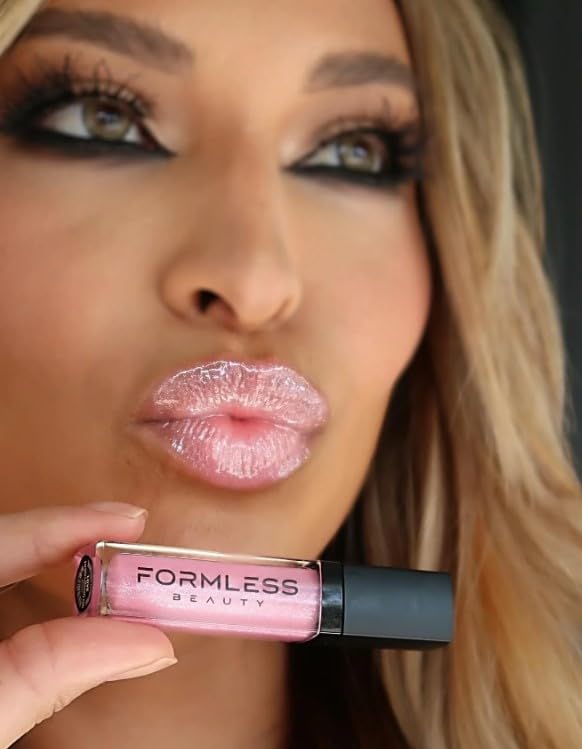 Formless Beauty Love Lip Gloss swatch on skin shows sheer pink pigment.